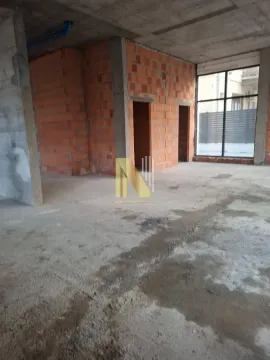 Interior of an unfinished commercial space in grey construction phase. - image 5