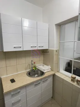 Small kitchen with white cabinets and a sink. - image 4