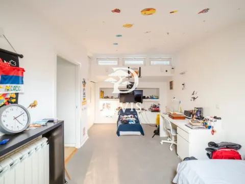 Children's bedroom with a bed, desk, and ceiling decoration. - image 6
