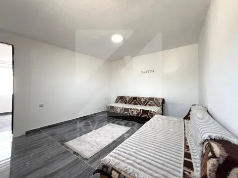 Living room with two sofas and dark flooring. - image 6