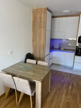 Modern kitchen with a dining table and LED lighting. - image 3