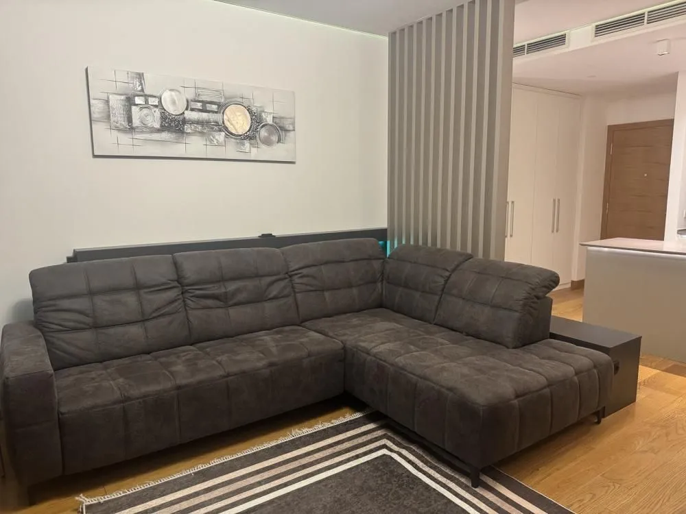 Comfortable living room with a sectional sofa and decorative wall art.