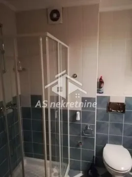 Bathroom with a shower cabin and toilet. - image 13