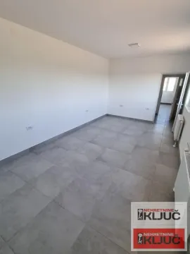 Empty room with gray floor tiles and white walls. - image 9