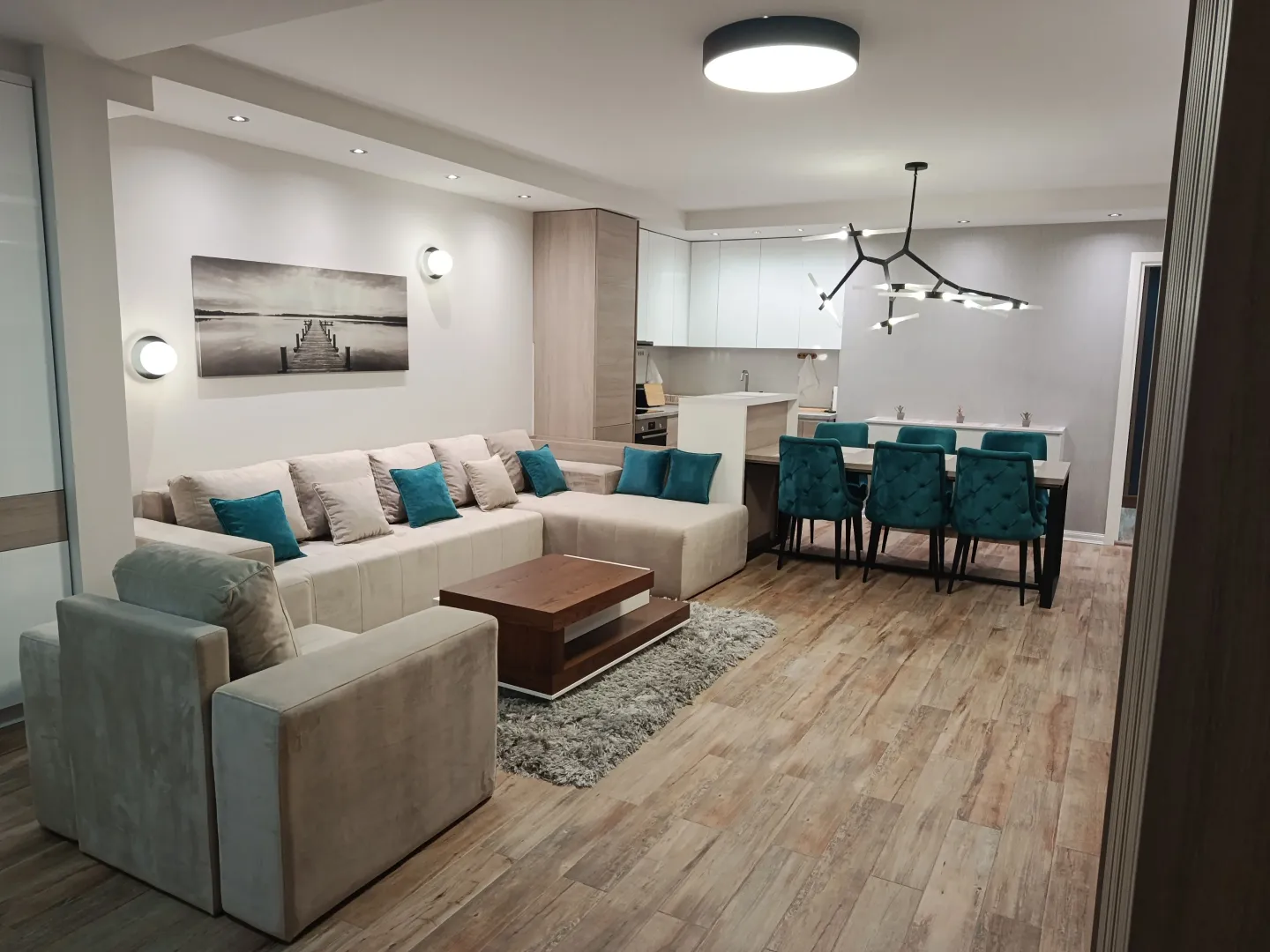 Living room with sofa set and dining area in an open plan layout.