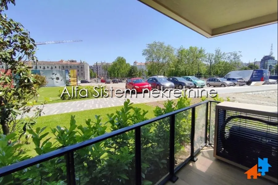 View from the covered terrace of the surrounding greenery and parking lot.
