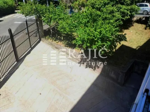 View from the building overlooking the courtyard and driveway with greenery. - image 17