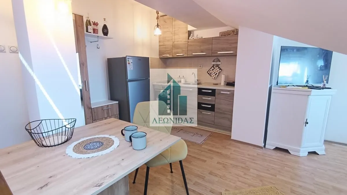 Kitchen with a dining table and chairs in the attic.
