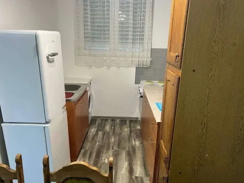Smaller kitchen with wooden units and white goods. - image 6