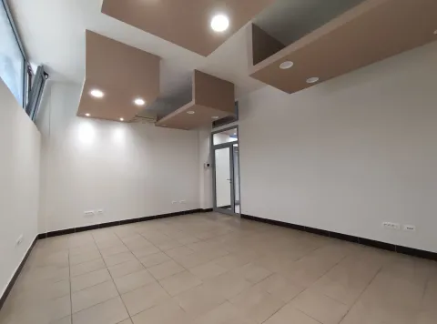 An empty spacious room with tiled flooring and decorative ceiling lighting. - image 3