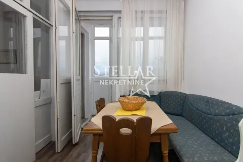 Dining area with a wooden table, corner sofa, and access to an enclosed terrace. - image 3
