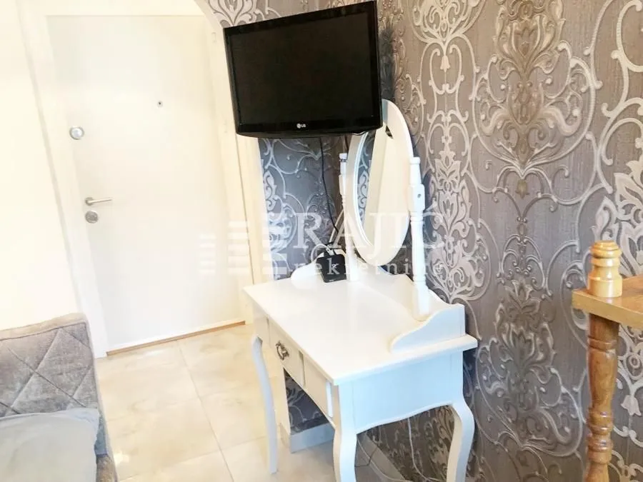 White dressing table with a mirror in the bedroom.