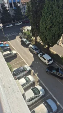 View from the property overlooking the street with parking and trees. - image 5