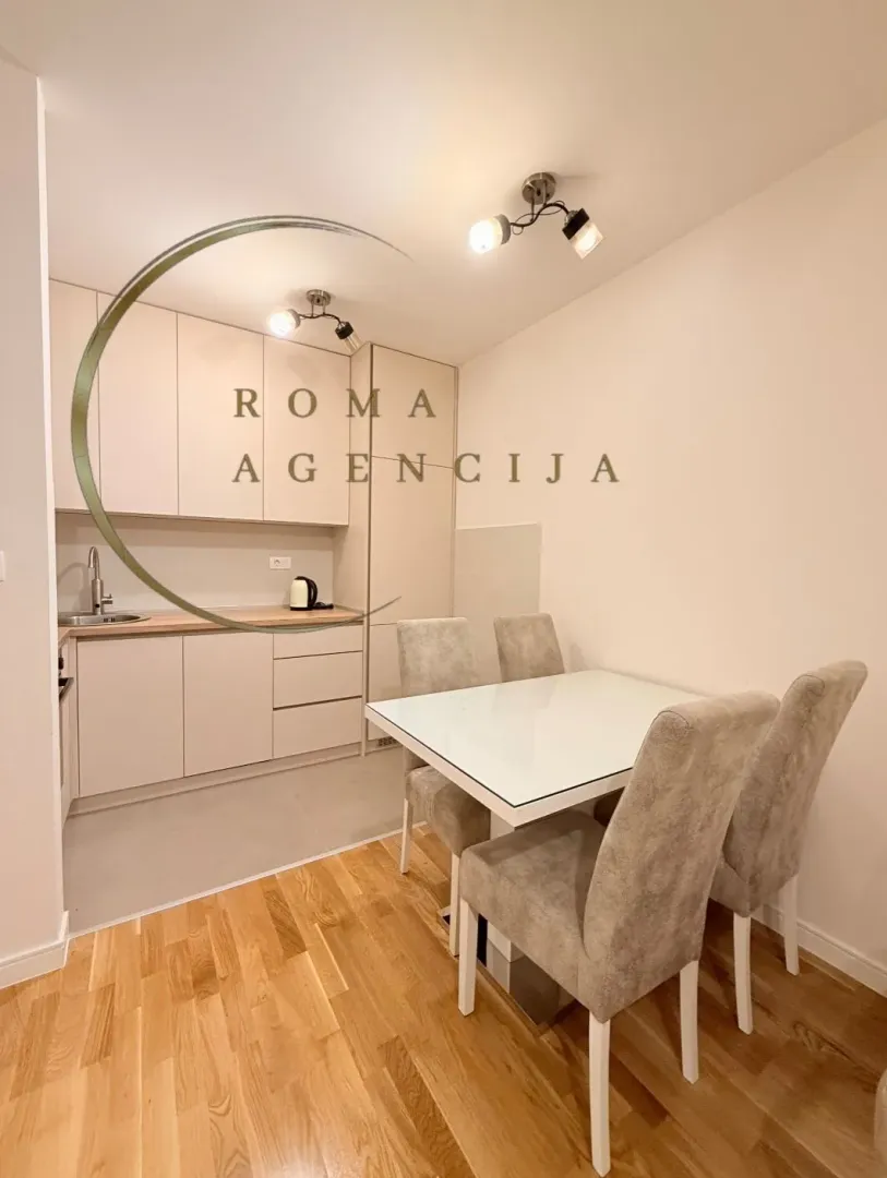 Small kitchen with a dining table and chairs.