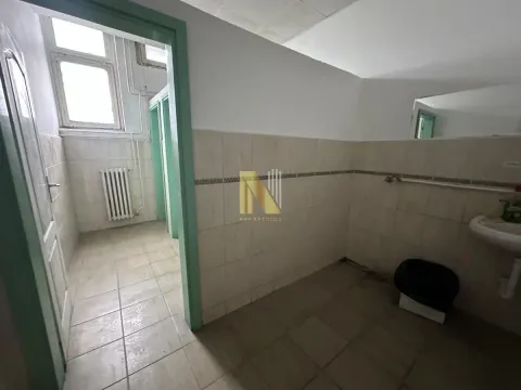 View of an older bathroom with a sink and tiles. - image 12