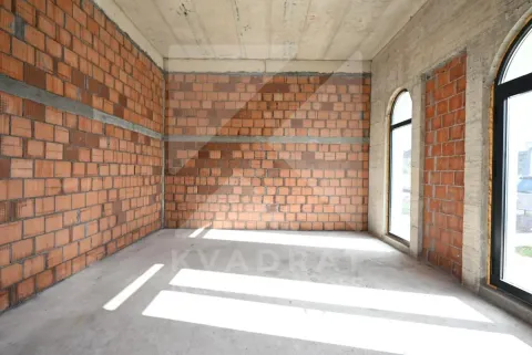 Unfinished room under construction with brick walls and arched windows. - image 7
