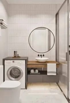 Moderno opremljeno kupatilo sa umivaonikom, okruglim ogledalom i veš mašinom. - image 10