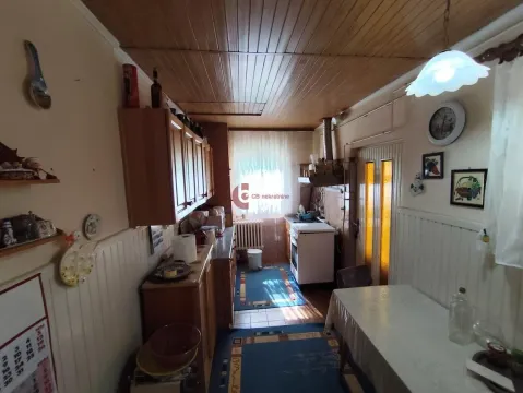 Smaller kitchen with a dining table and wood paneling on the ceiling. - image 20