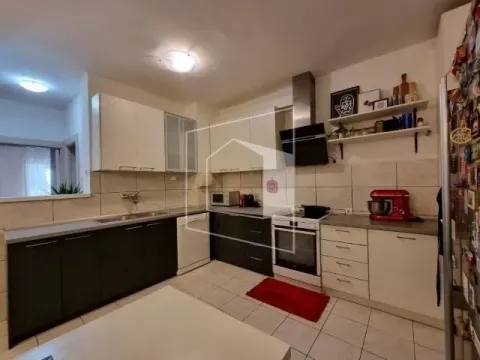 Spacious kitchen with white and dark cabinetry and built-in appliances. - image 5