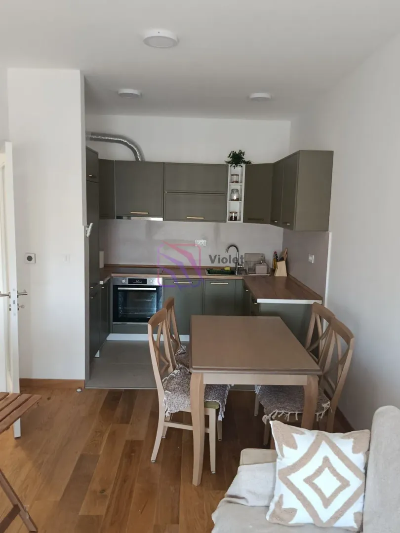 Small kitchen with a dining table and chairs.