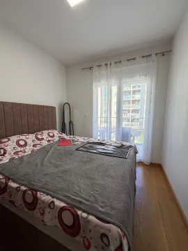 Bedroom with a double bed and balcony access. - image 6