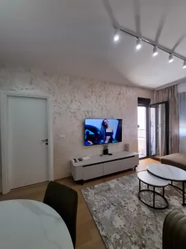Modern living room with a sofa, TV, and access to the terrace. - image 4