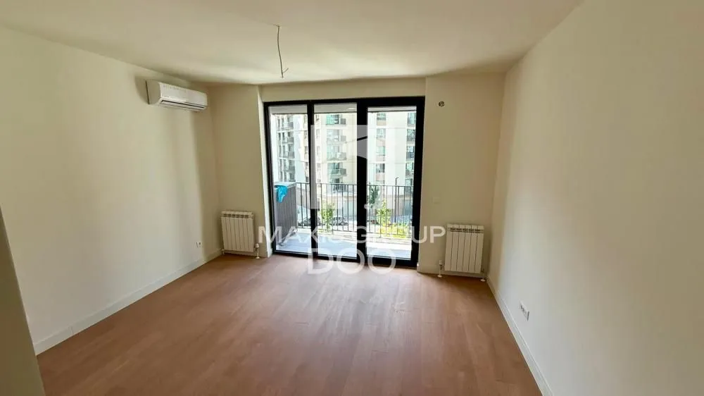 Empty room with wooden flooring, air conditioning and access to the terrace.