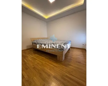 Bedroom with a double bed and wooden flooring. - image 9