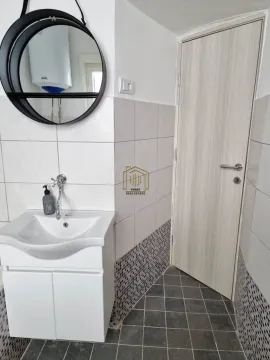 Small bathroom with a washbasin, mirror and a door. - image 2