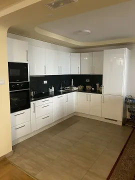 Bright kitchen with white cabinets. - image 19