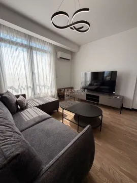 Modern living room with a corner sofa, TV, and coffee table. - image 3