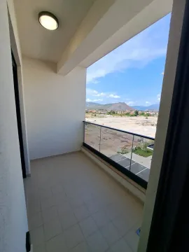 Unfurnished balcony with a glass railing and a view of the surroundings. - image 8