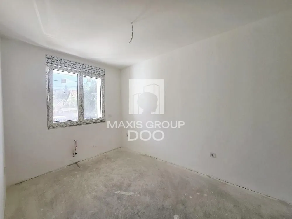 Empty unfinished room with a single window.