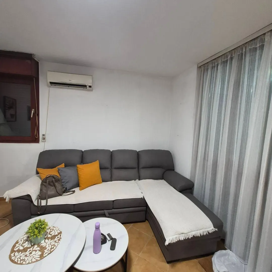 Living room with a sectional sofa and a coffee table.