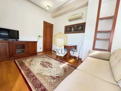 Living room with a sofa, dining table, and wooden furniture. - image 7