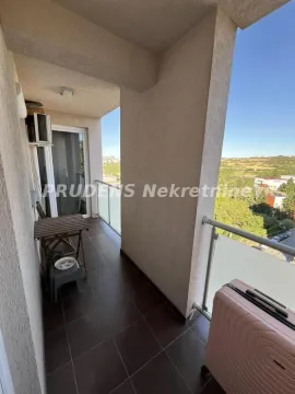 Covered balcony space with a small table and a view of the surroundings. - image 5