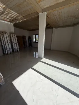 Interior of an empty room under construction with ceramic tile flooring. - image 6