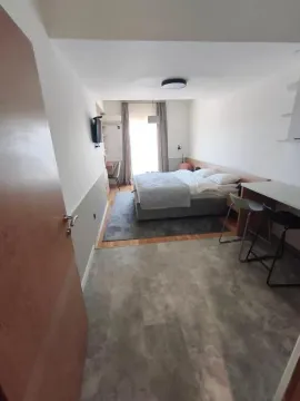 Modern bedroom with a double bed and a desk. - image 14