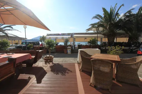 Restaurant terrace with seating furniture and a sea view. - image 13