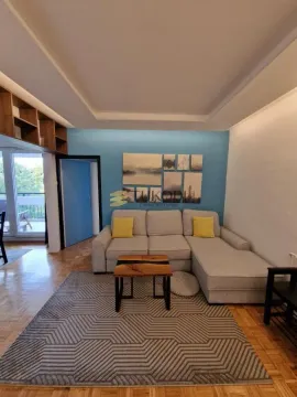Living room with a sectional sofa, coffee table, and access to the terrace. - image 2