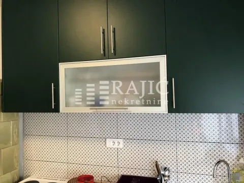 Part of the kitchen with dark cabinets and ceramic tiles. - image 6