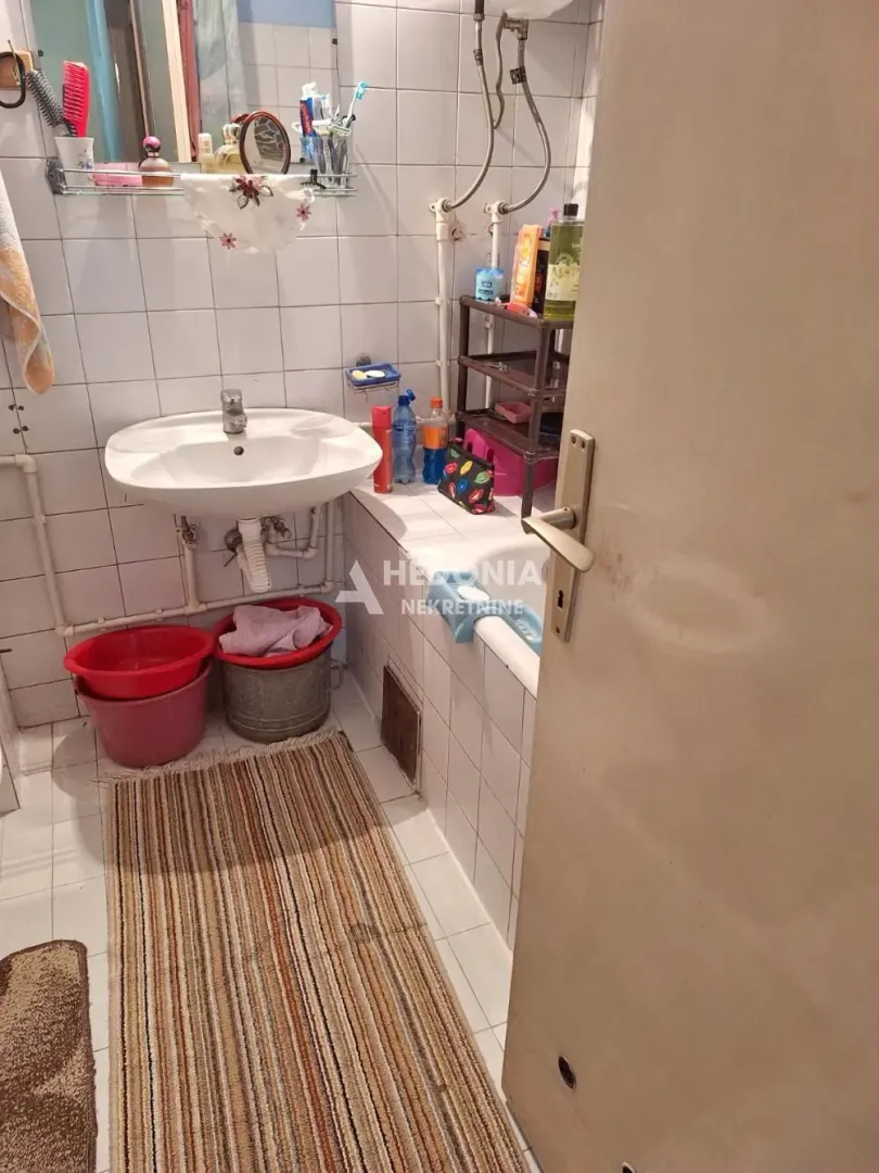 View of the bathroom with a sink and tiling.