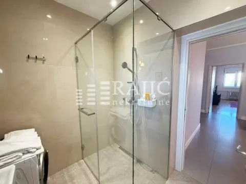 Modern bathroom with a shower cabin and glass partition. - image 10