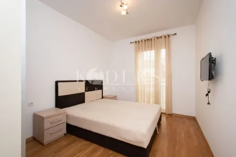 Bedroom with a double bed, nightstands, and a wall-mounted TV. - image 5