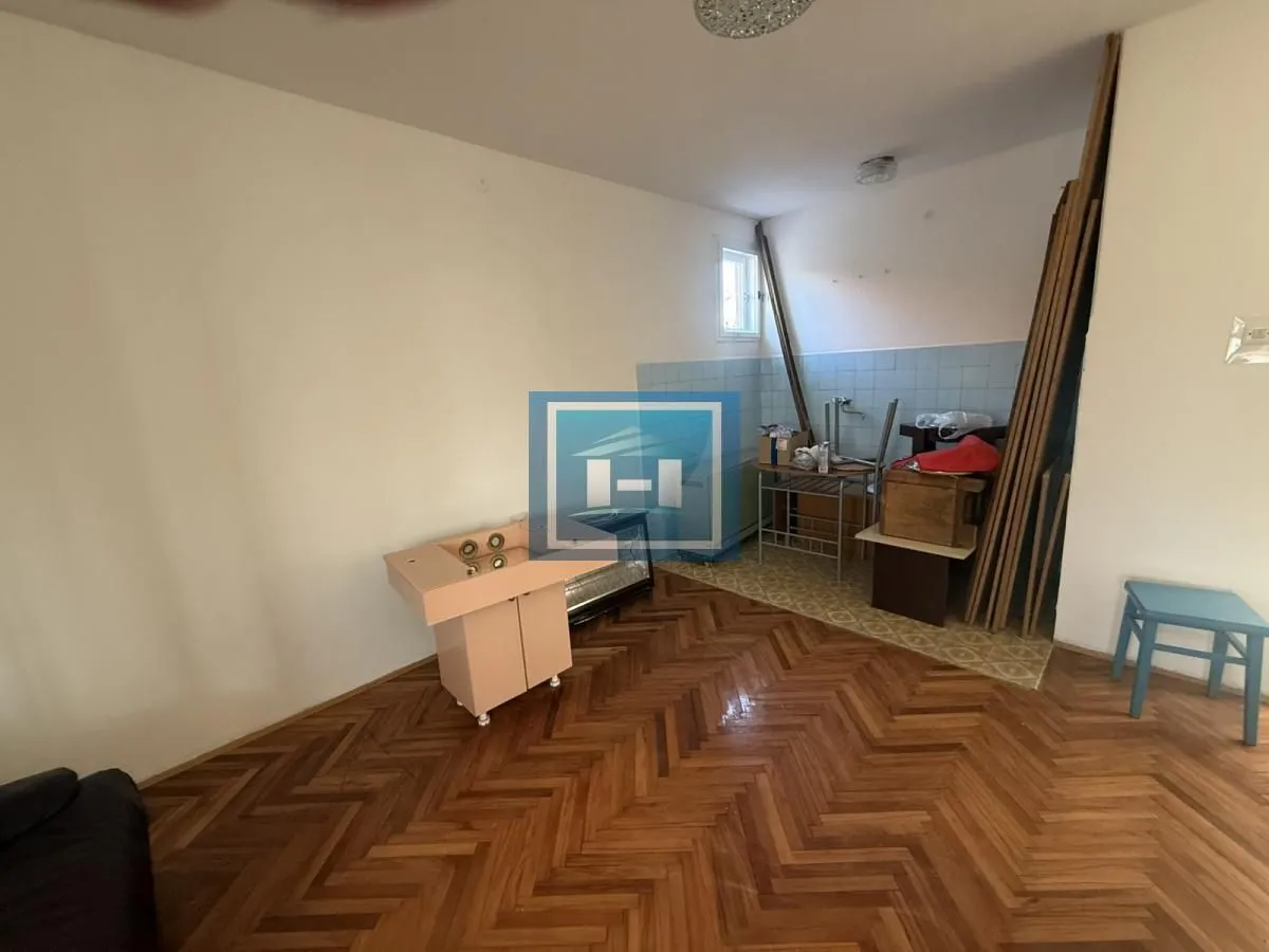 Older kitchen with wooden parquet flooring and wall tiles.