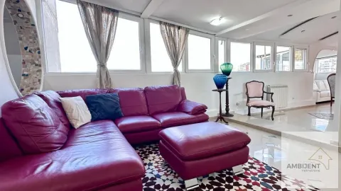 Spacious living room with a large sofa and large windows. - image 2