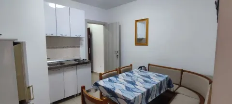 Small kitchen with a dining table and corner bench. - image 2