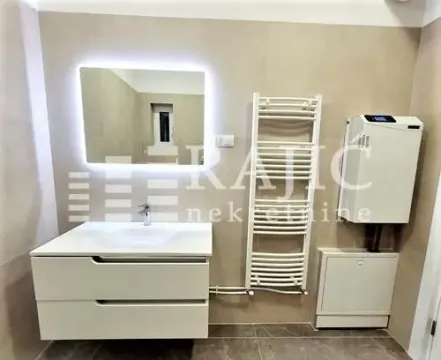 Modern bathroom with a washbasin, mirror and towel warmer radiator. - image 14
