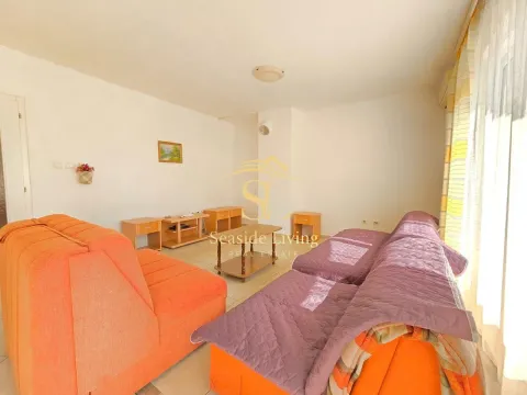 Living room with a sofa set and wooden furniture pieces. - image 2
