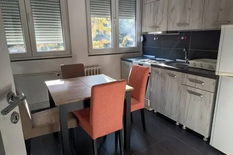 Kitchen with a dining table and chairs near the window. - image 4